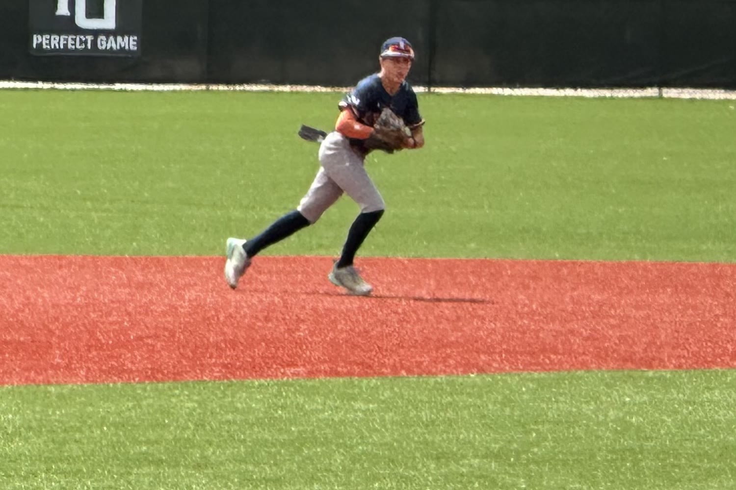 Brayden Palomino ranging in the middle infield during a Perfect Game event